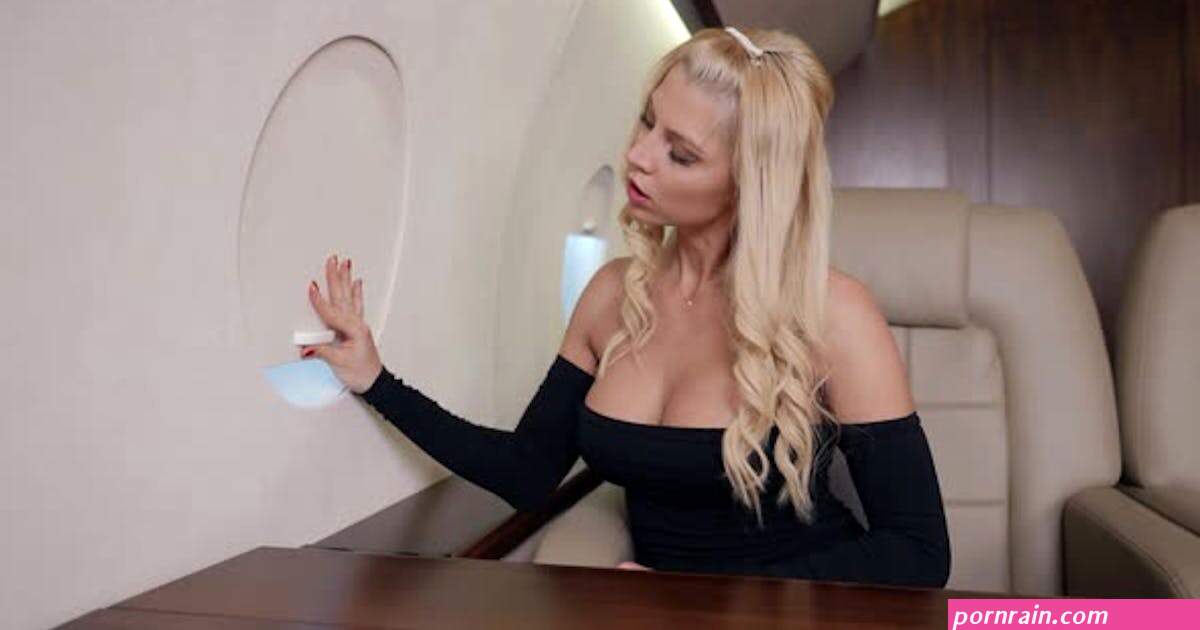 Busty Blonde Woman is Viewing Into Porthole of Private Plane Traveling By First Class, Stock Video