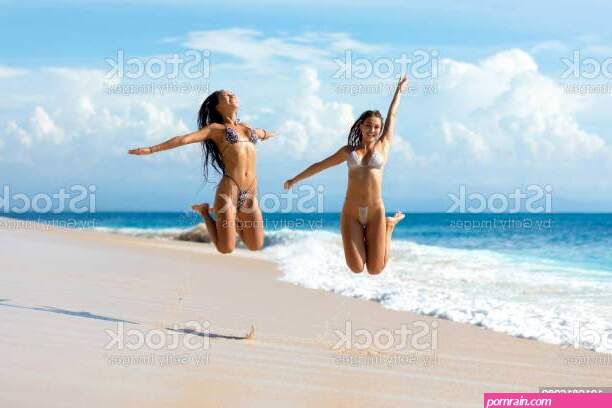 Two Young Women Enjoying The Beach Stock Photo