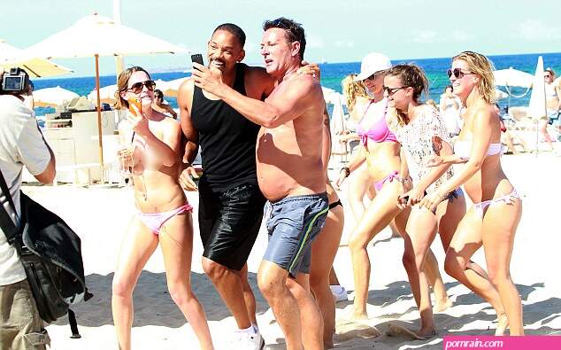 Topless women spotted following Will Smith around as he relaxes on the beach in Ibiza