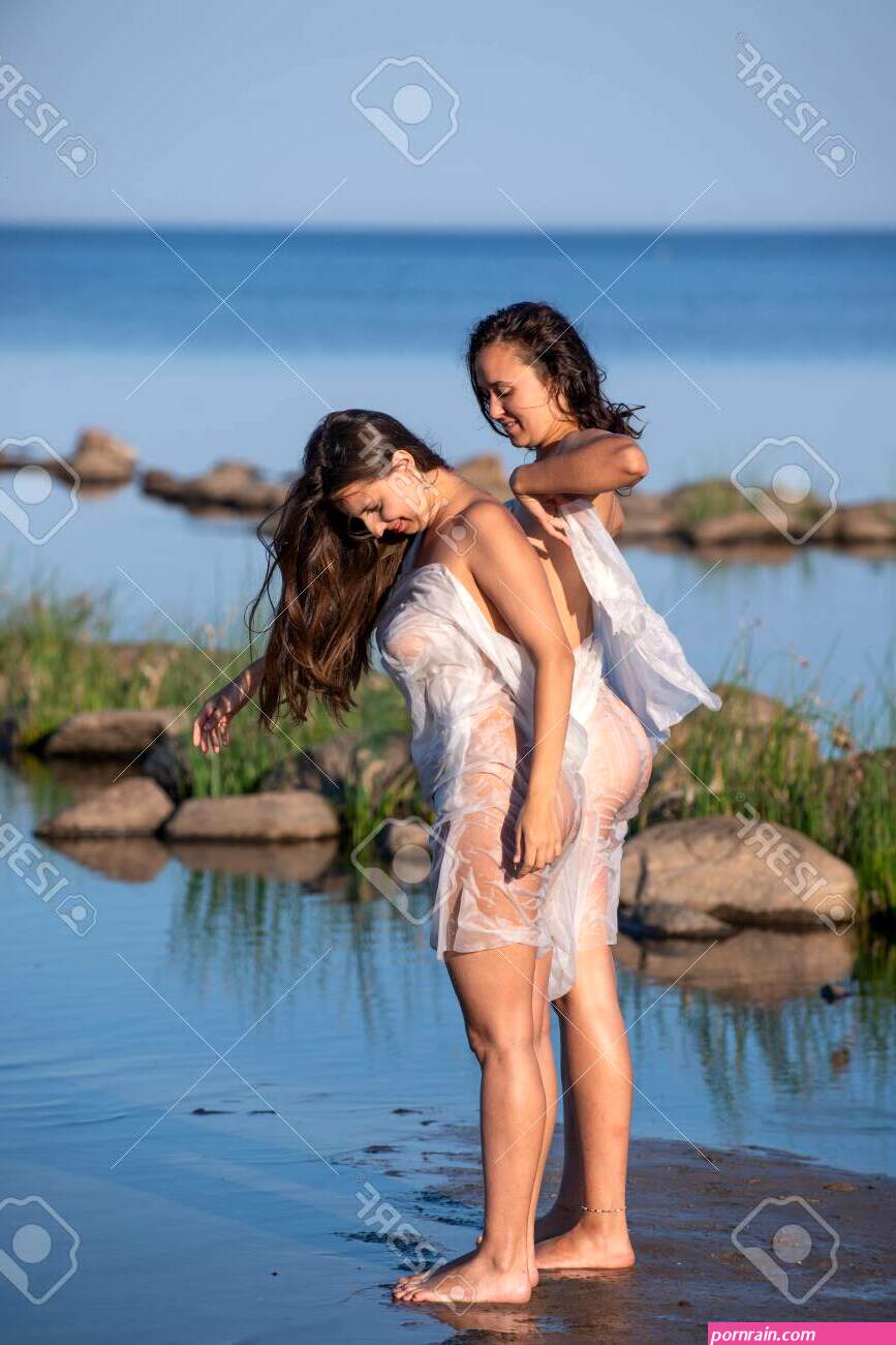 Two Young Nude Women Wrapped In White Shawl Posing On The Beach. Sexy Naked Brunettes Enjoying Summer Time Outdoors Stock Photo, Picture And Royalty Free Image. Image 143762696.