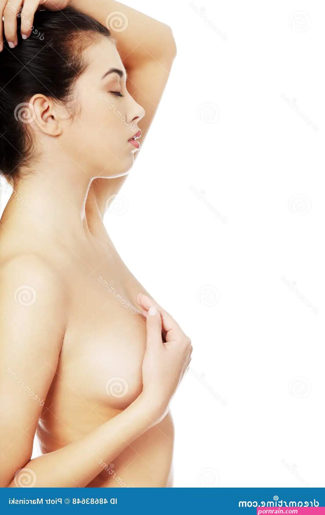 Side View of Nude Woman Touching Her Breast Stock Photo