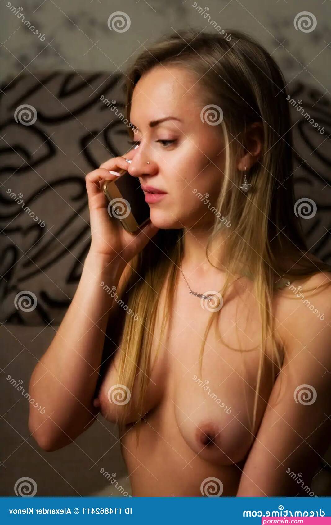 A Girl with a Beautiful Naked Breast Communicates by Phone. Stock Image