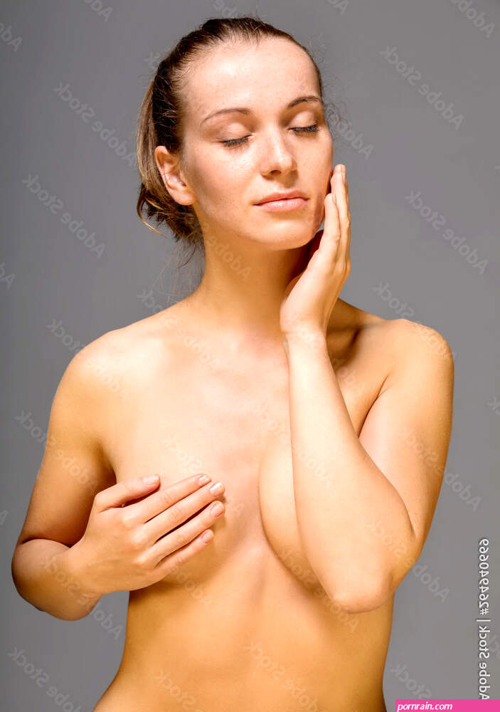 Young nude woman with covered breast touching face. Skin pampering concept.  Stock Photo | Adobe Stock