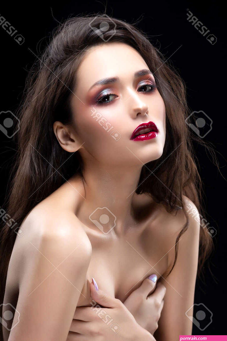 Portrait Of A Beautiful Glamorous Brunette Girl Sensually Covers Her Naked  Breast With Her Hands. Shimmering Makeup, Red Lips. Healthy Smooth Skin.  Isolated On Black. Copy Space. Stock Photo, Picture And Royalty