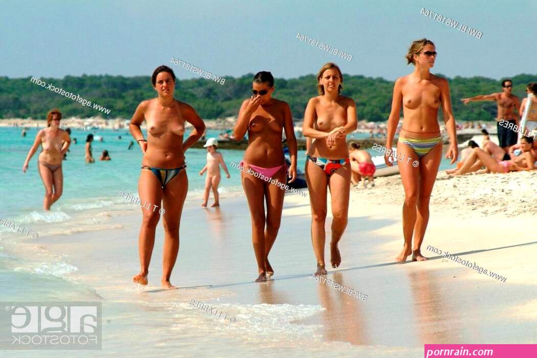 four young semi-nude women walking along the beach Spain Balearen Stock Photo Picture And Rights Managed Image. Pic. BWI-BLWS181764