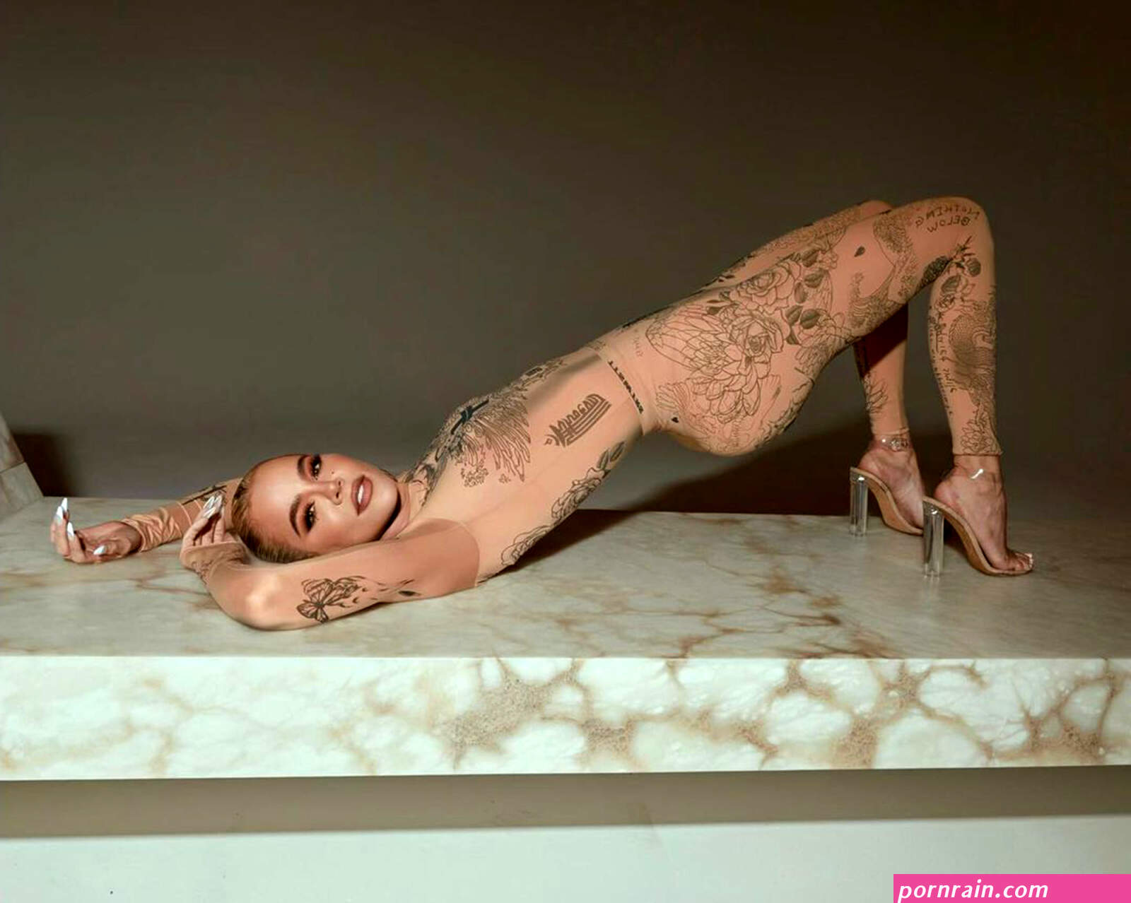 Khloé Kardashian rocks nude catsuit covered in tattoos