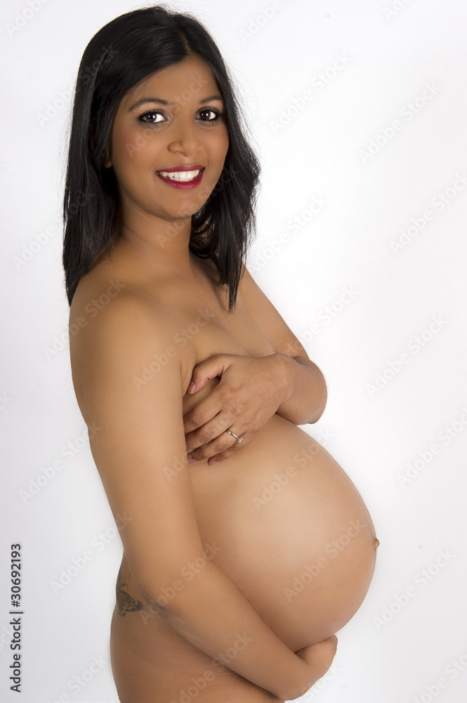 Sexy beautiful pregnant Indian woman in nude smiling Stock Photo