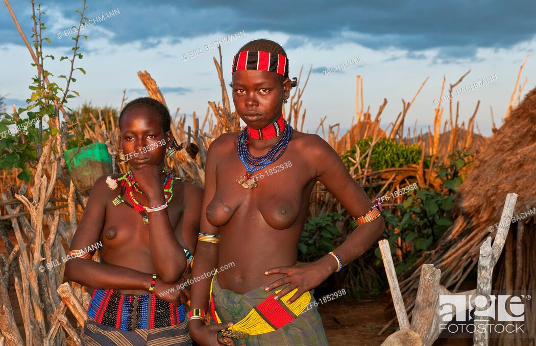 Turmi Ethiopia Africa village Lower Omo Valley Hamar Hammer tribe two nude teemager girls at sunset... Stock Photo Picture And Rights Managed Image. Pic. ZF6-1852938