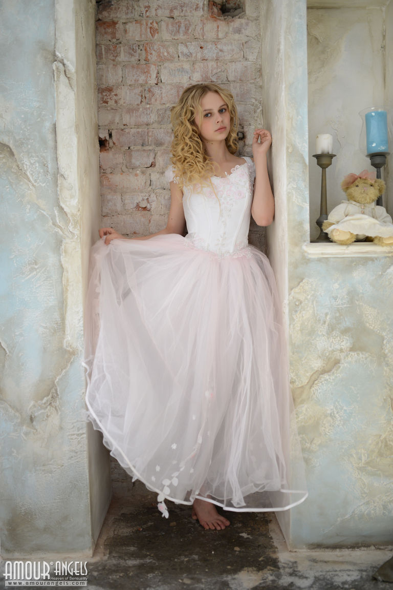 Blonde teen strips off her bridal gown and cotton panties for nude poses