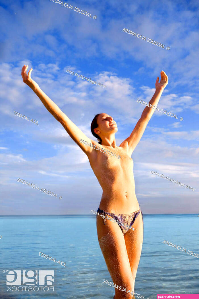 Semi-nude woman with arms raised at beach Stock Photo Picture And Rights Managed Image. Pic. EXA-JA3-0937