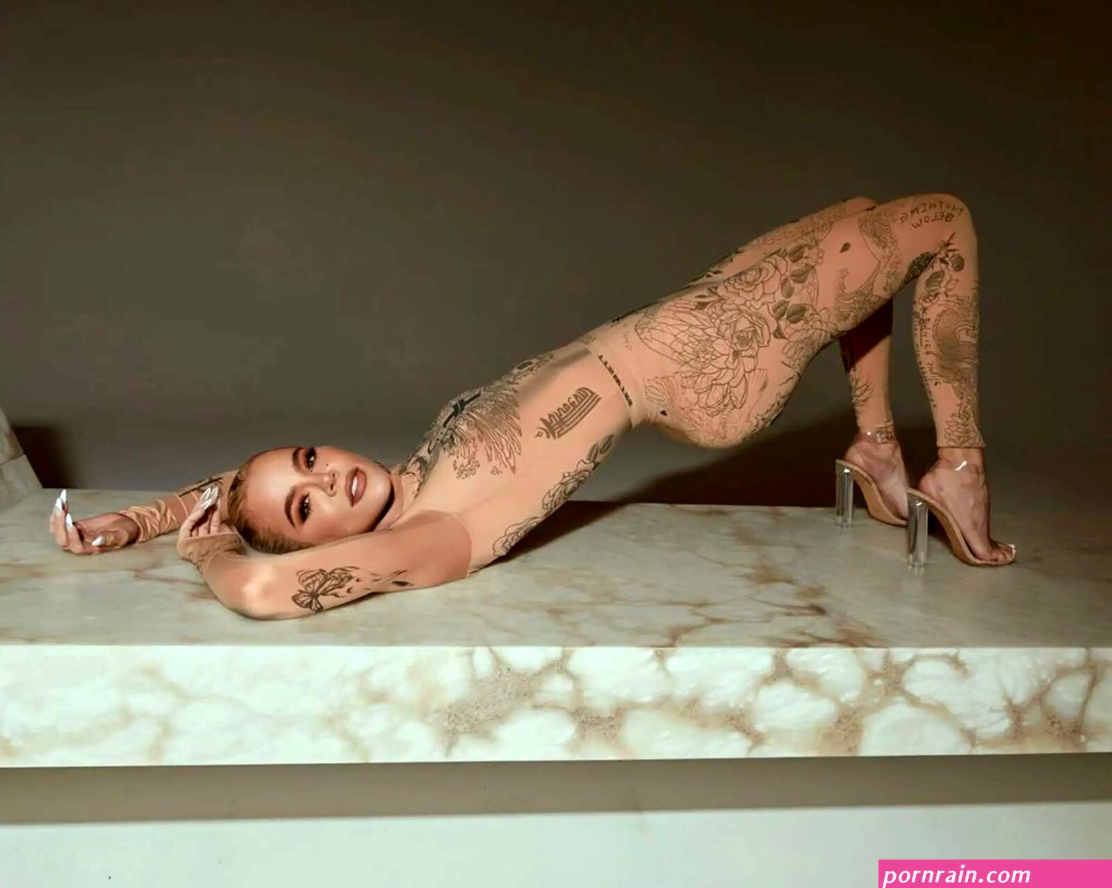 Khloé Kardashian rocks nude catsuit covered in tattoos