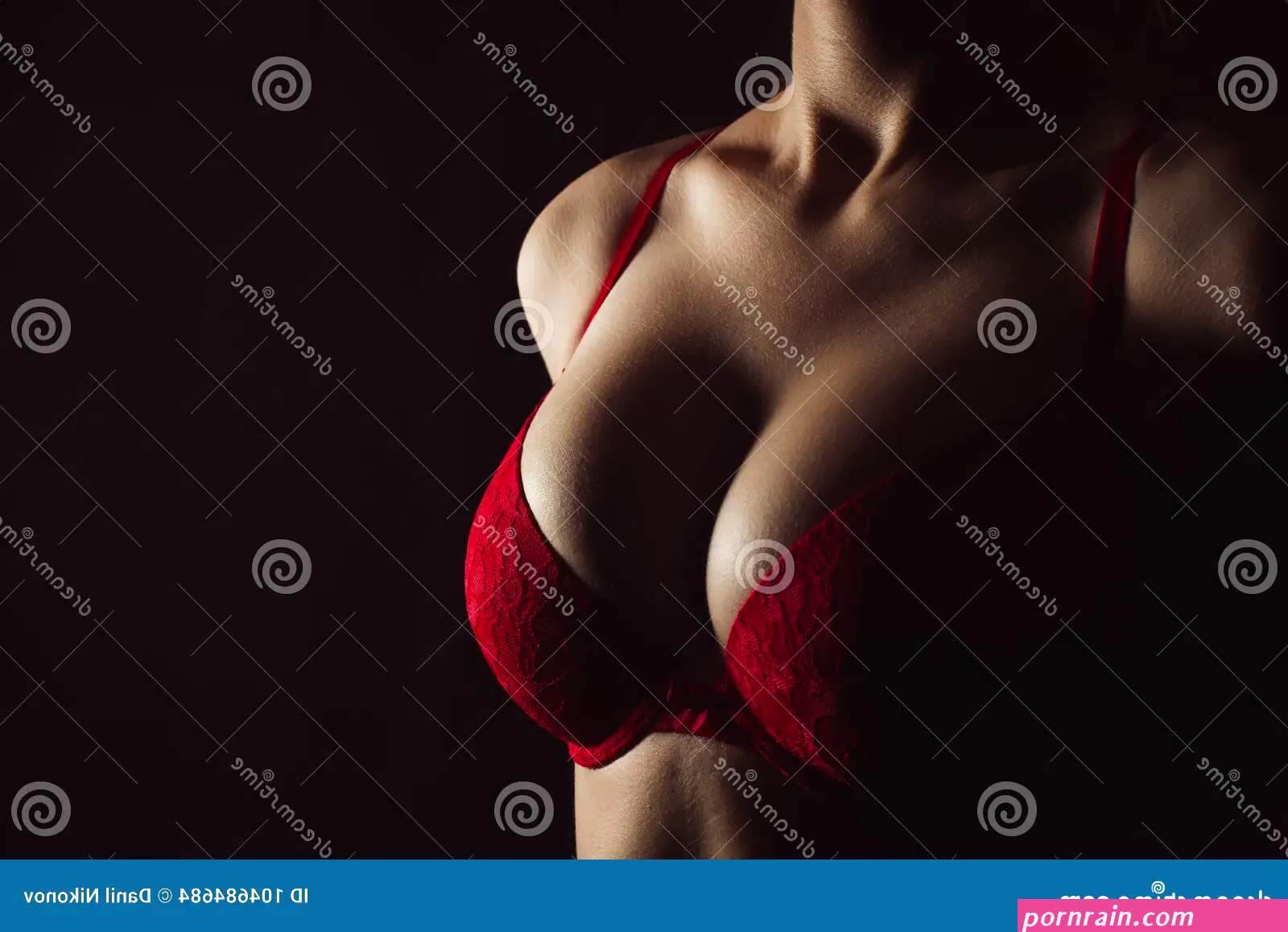 Woman with Hot Breasts in Lingerie. Seductive Red Bra and Big Boobs Stock Photo