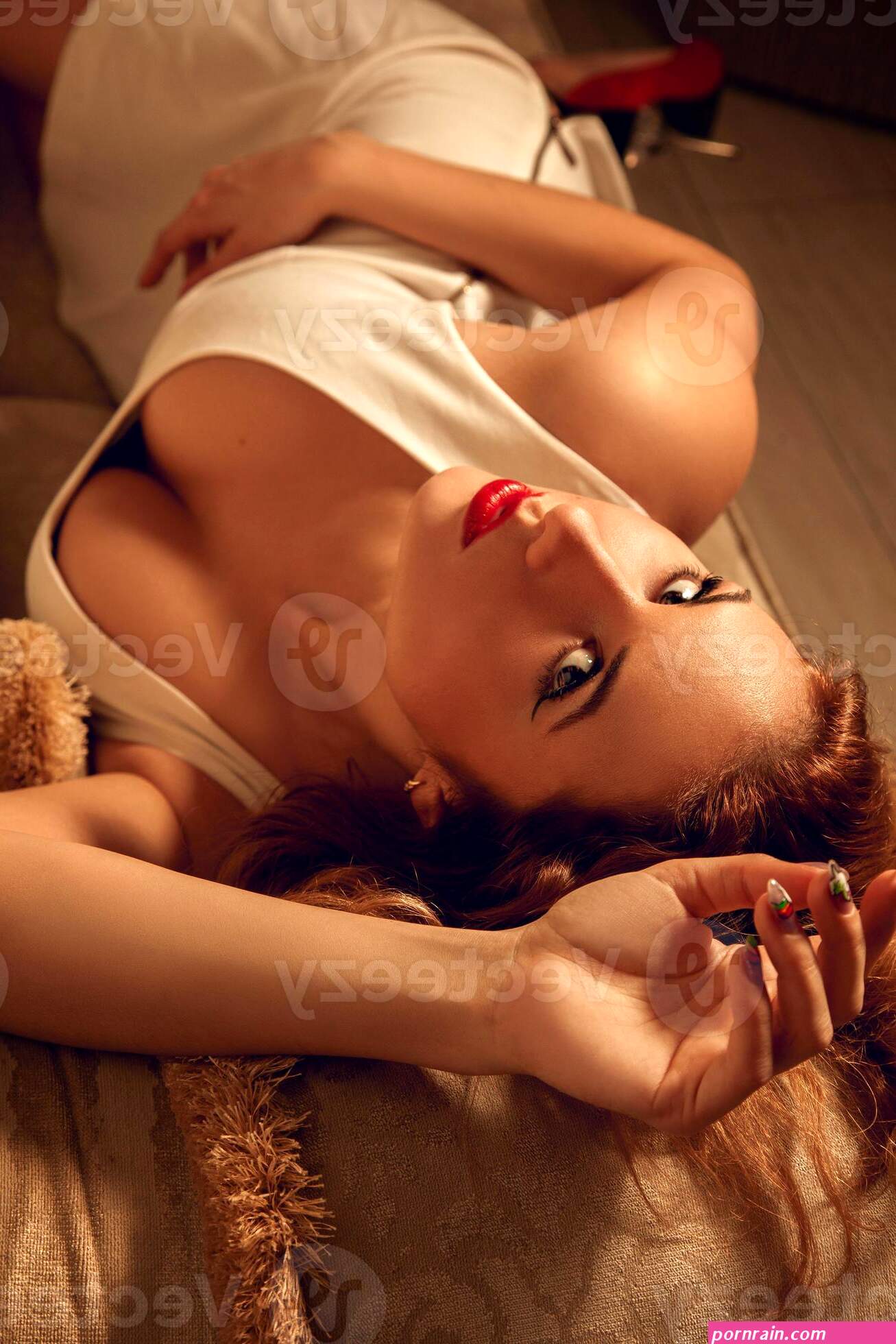 Vertical close up portrait of young sexy woman with curly hair and big natural breast looking at camera 16390009 Stock Photo at Vecteezy