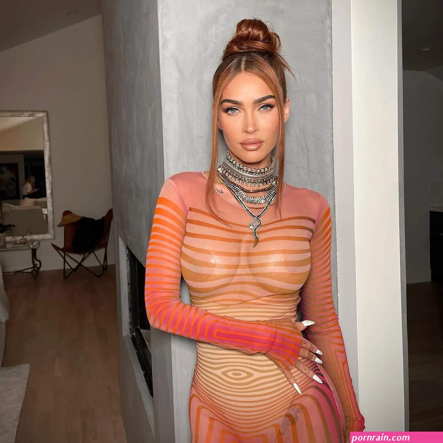 Megan Fox flaunts her curves as she goes braless in see-through orange dress for very sexy new pics