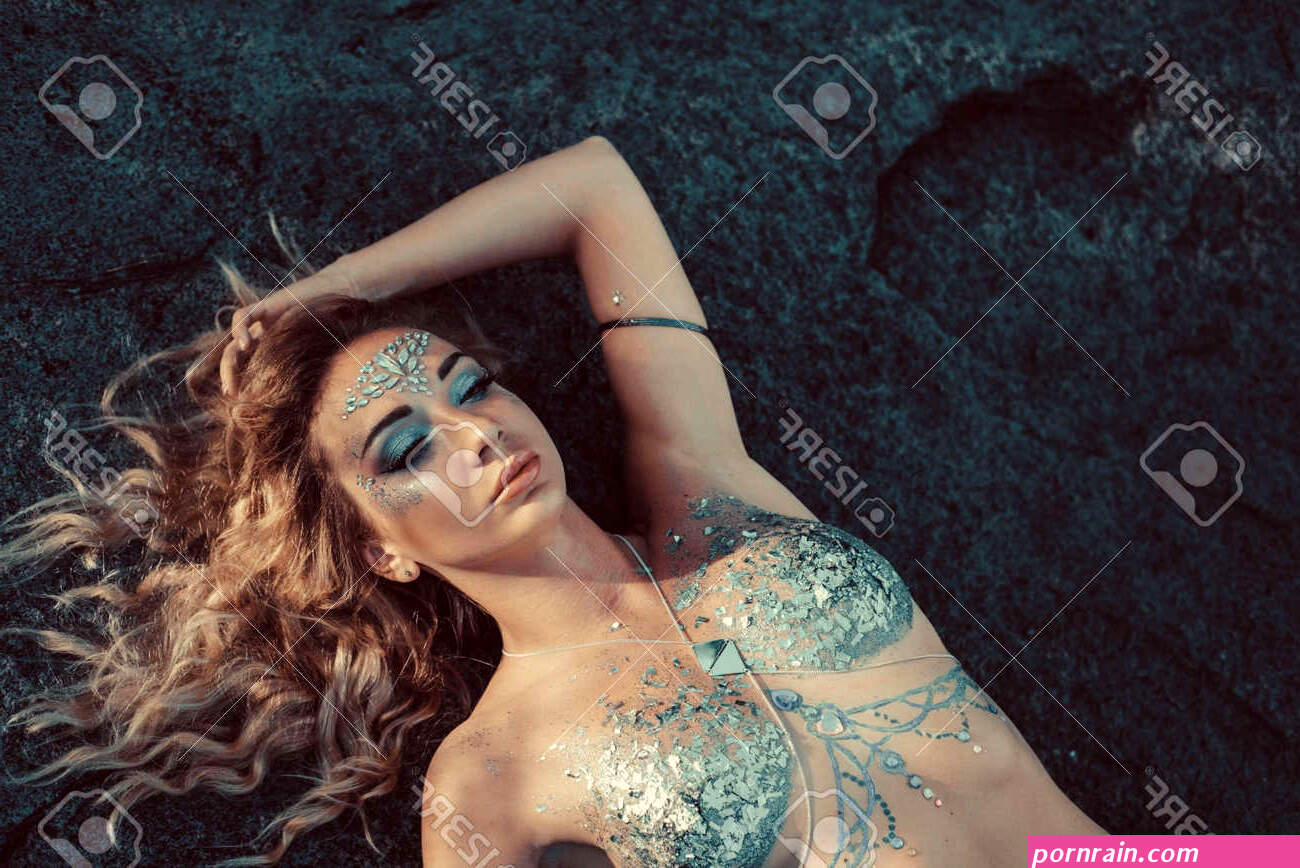 Portrait Of A Young Girl Body Art Nude Lies On Stone Rocks Model Posing. Girl Blonde Twenty-nine Years Old Nude With Designer Makeup On The Body Body Art Nymph Forest Maiden Elf