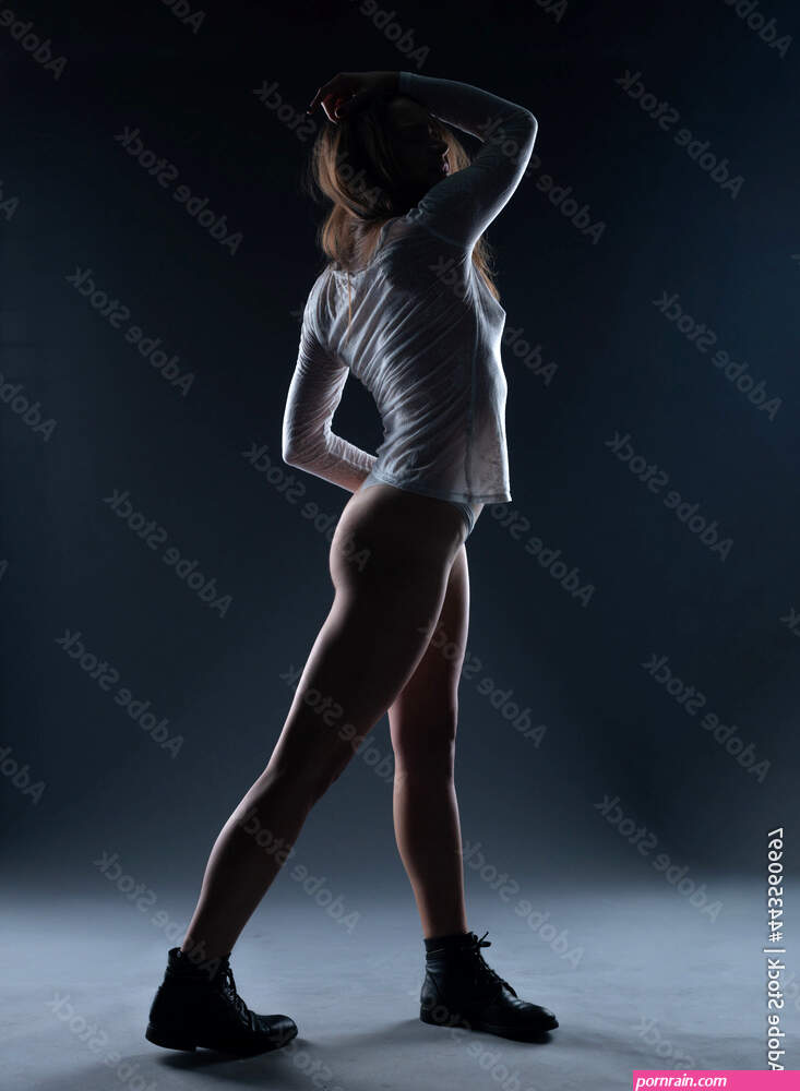 Art nude perfect naked body sexy young woman on dark background black and white photography studio shot Stock Photo