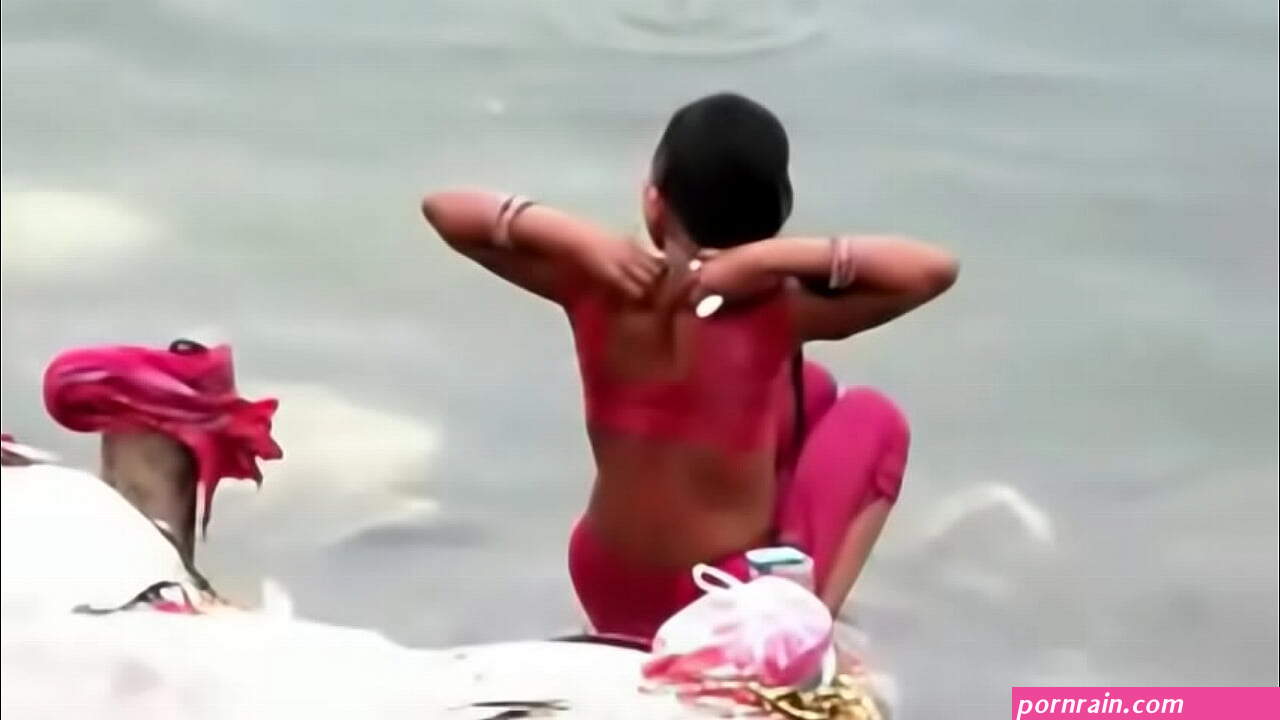 Indian woman bathing in ganges river backless open
