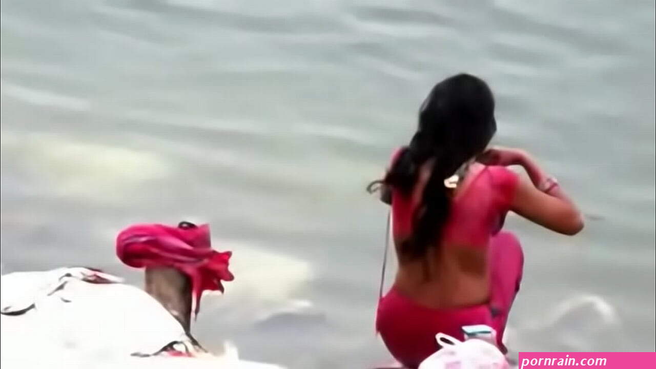 Indian woman bathing in ganges river backless open