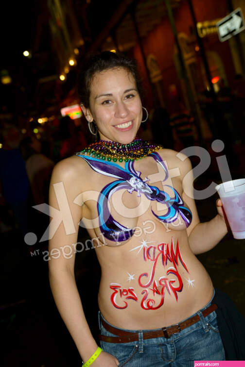 Woman At Mardi Gras With Fleur-De-Lis Painted Over Breasts Stock Photo