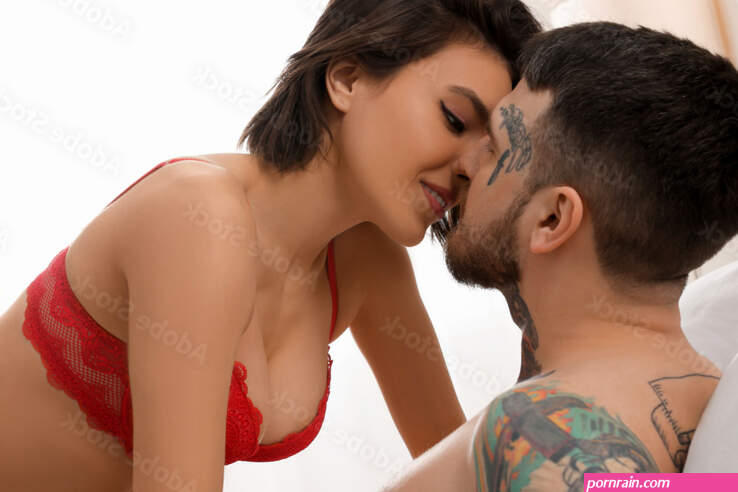 Passionate couple having sex on bed at home Stock