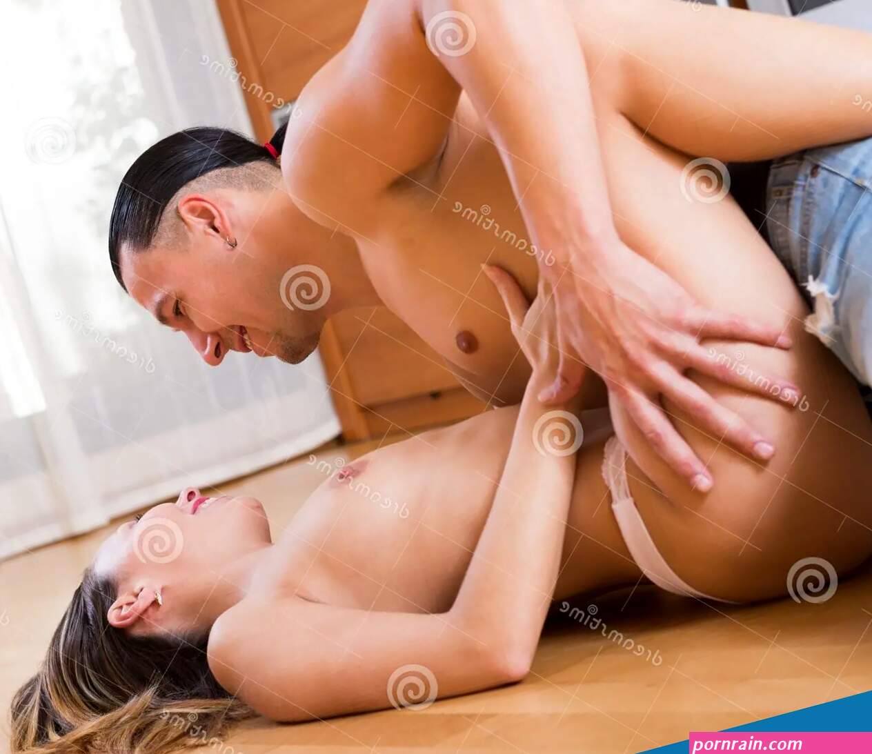Couple Having Sex on Floor at Home Stock Image
