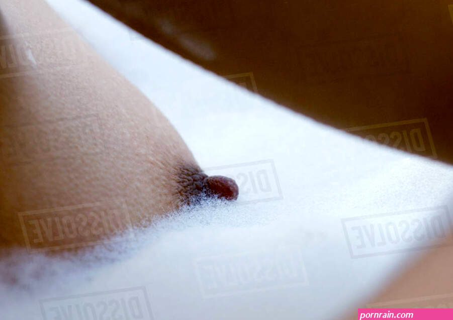 Womans breast in bubble bath