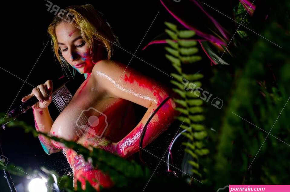 A Woman With Very Large Breasts Washes Body Paint In The Shower. Paint Flows Down The Naked Body Of A Girl In The Bathroom. Stock Photo Picture and Royalty Free Image. Image