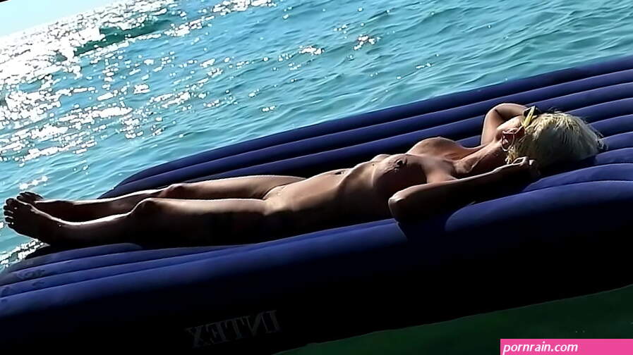 I spied on a nudist beach how a naked girl with big tits floats on a mattress and sunbathes.Slow motion